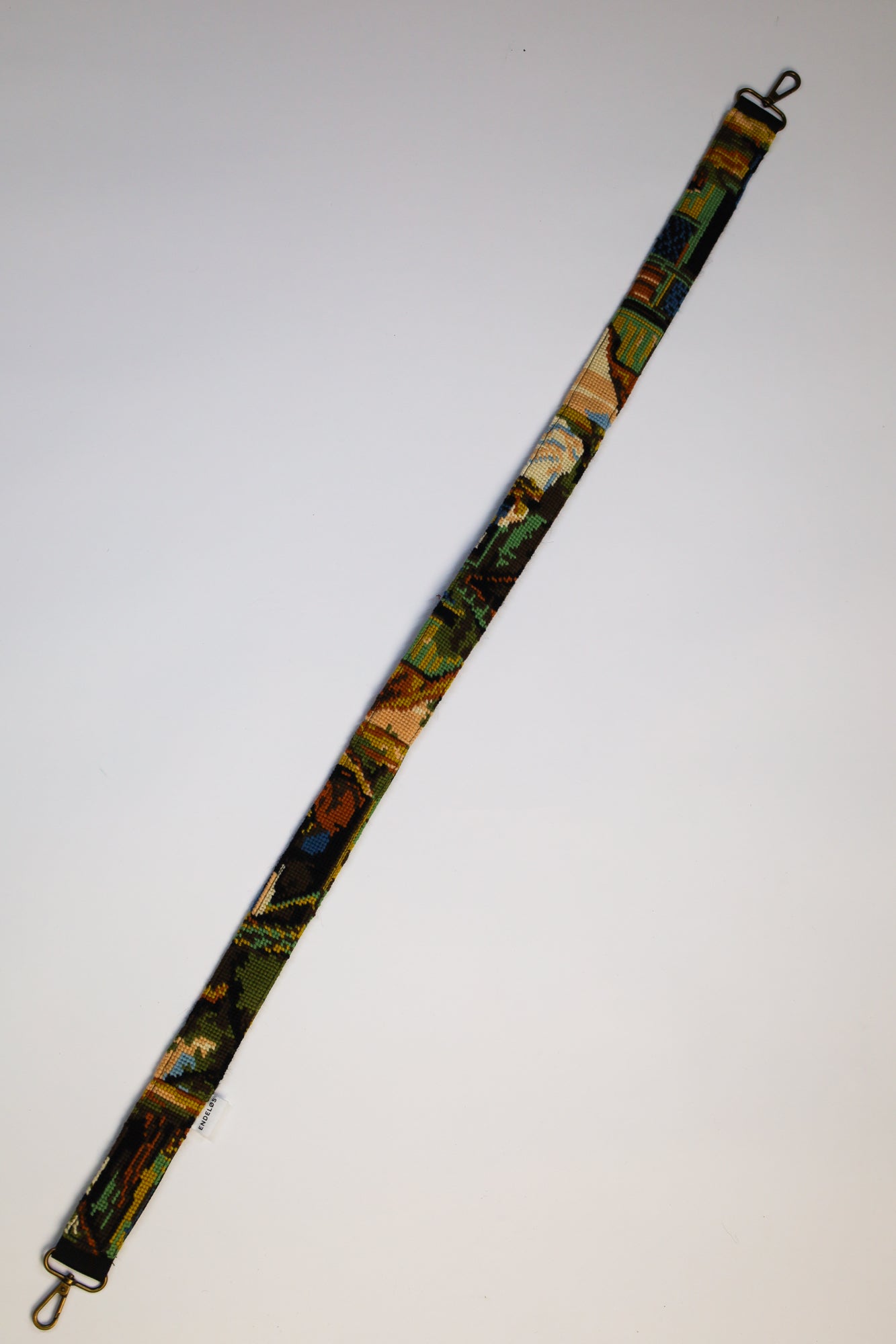 Unique strap with an embroidery of rural life, a stylish and sustainable addition to your bag or camera.