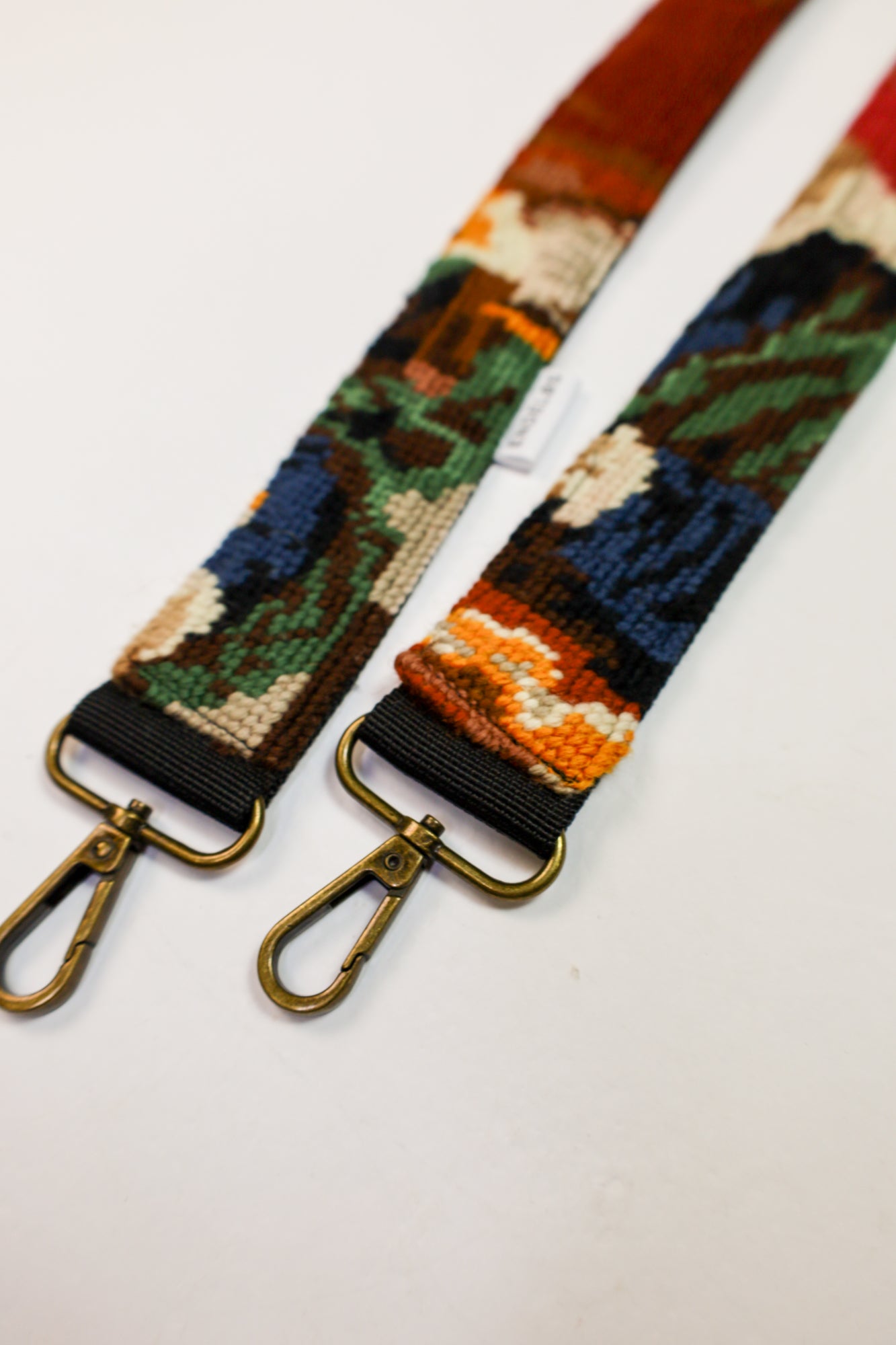 Sustainable strap with an artistic design based on The Gold Weigher, made from upcycled materials.