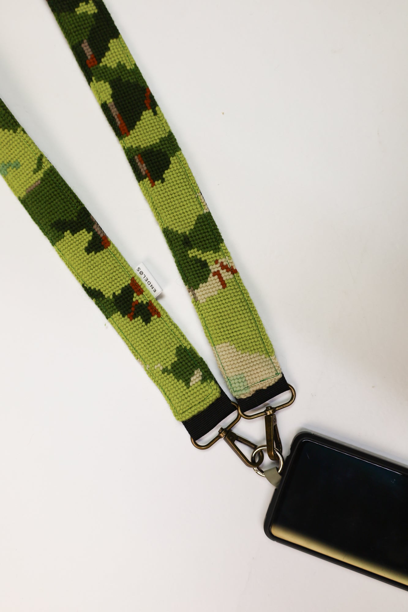Strap gemaakt van een kleurrijk geborduurd schilderij in groentinten, perfect voor het verfraaien van je tas, telefoon of camera.