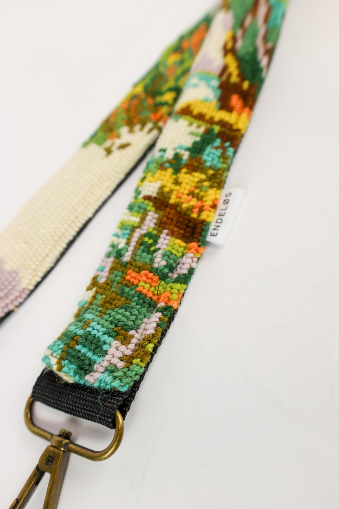 Strap met een gedetailleerd geborduurd boslandschap, een duurzaam en stijlvol accessoire voor tas, telefoon of camera.