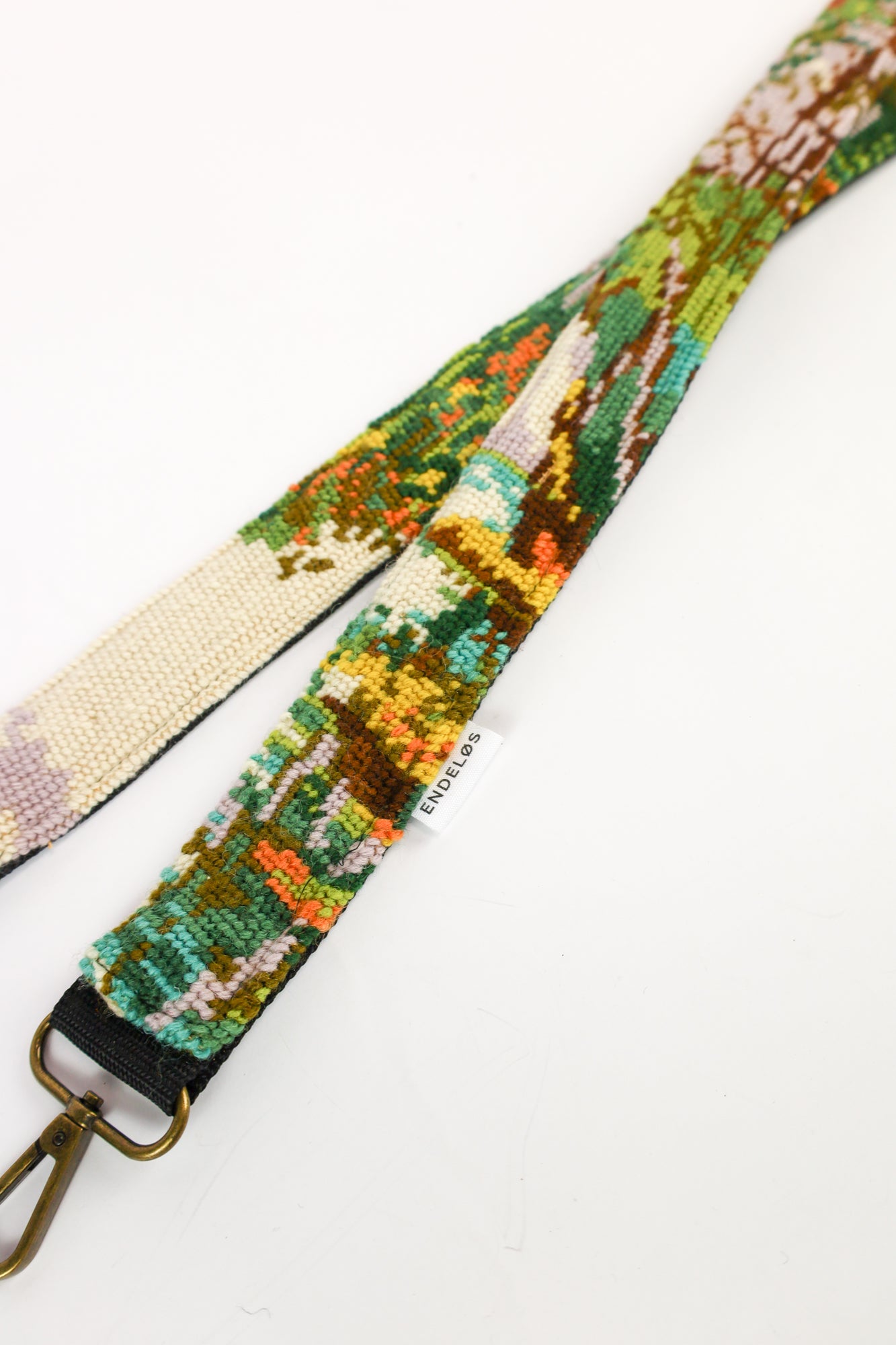 Strap with a forest embroidery design in earthy tones and lilac accents, ideal for adding a unique flair to your accessories.