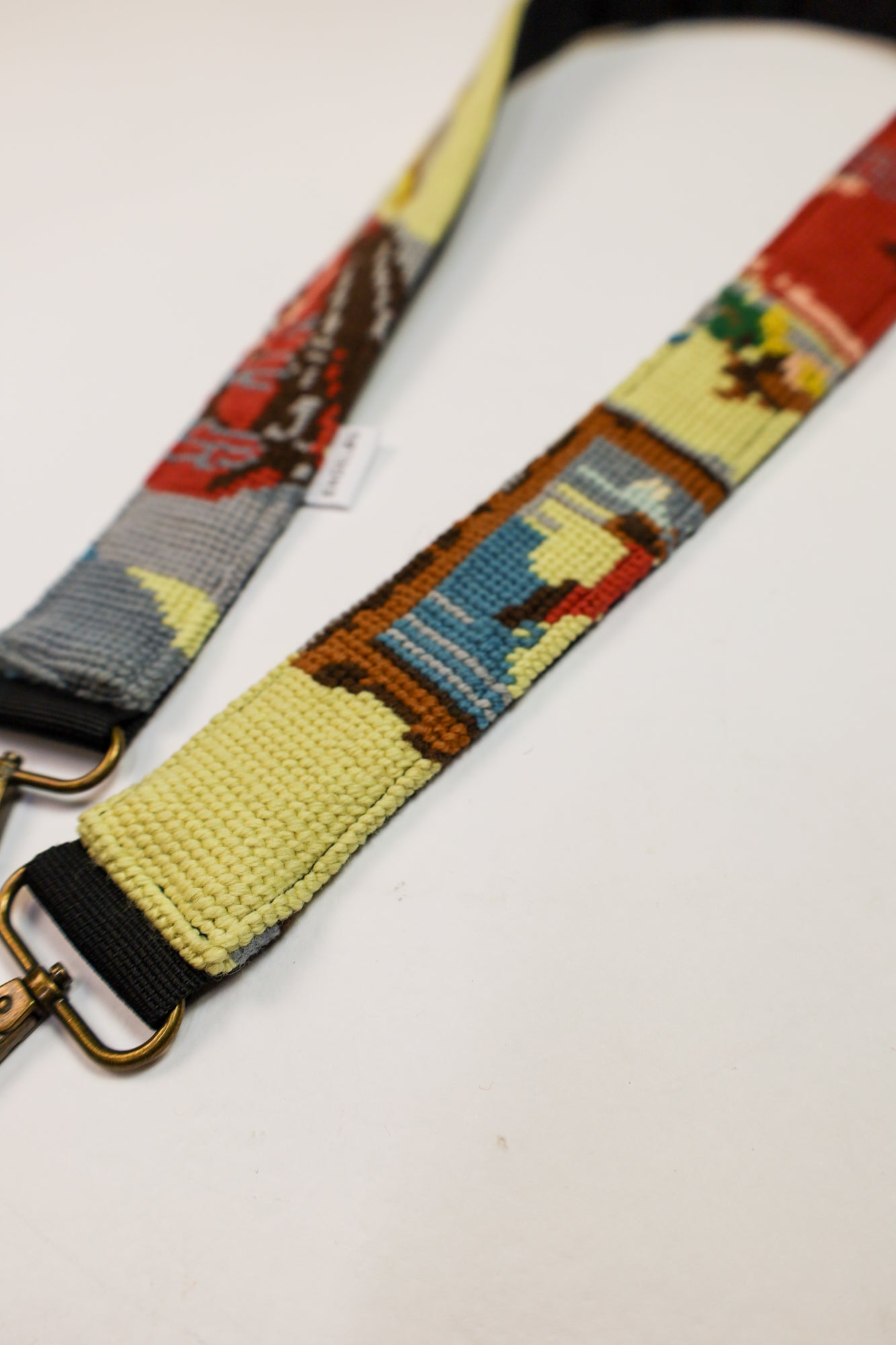 Unique strap with a colorful embroidered artwork in soft colors, ideal for adding a personal touch to your accessories.