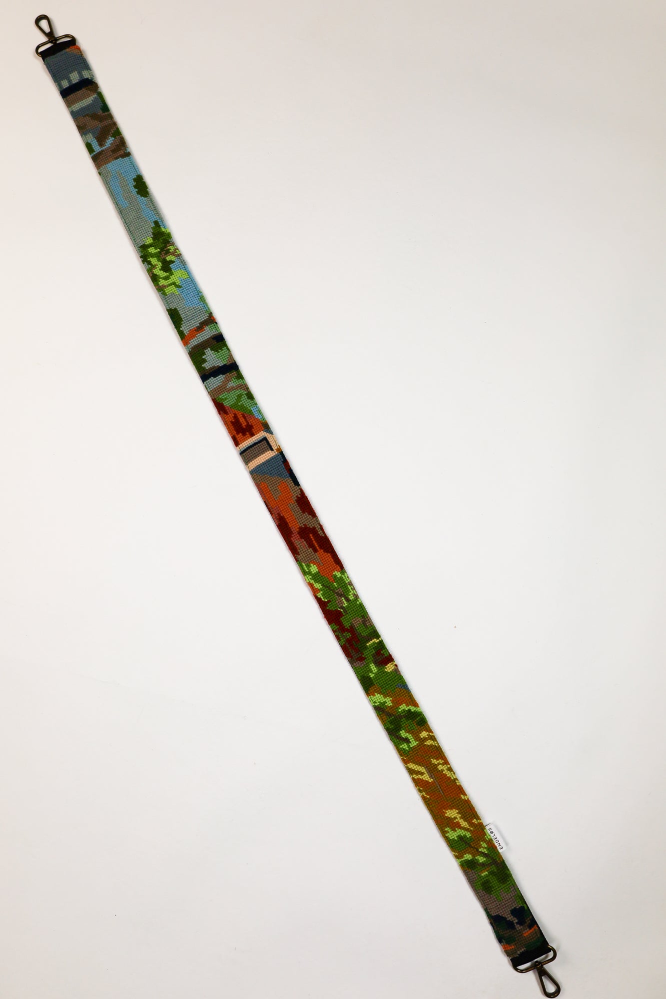  Unique strap with an embroidery of a landscape, a stylish and functional accessory.