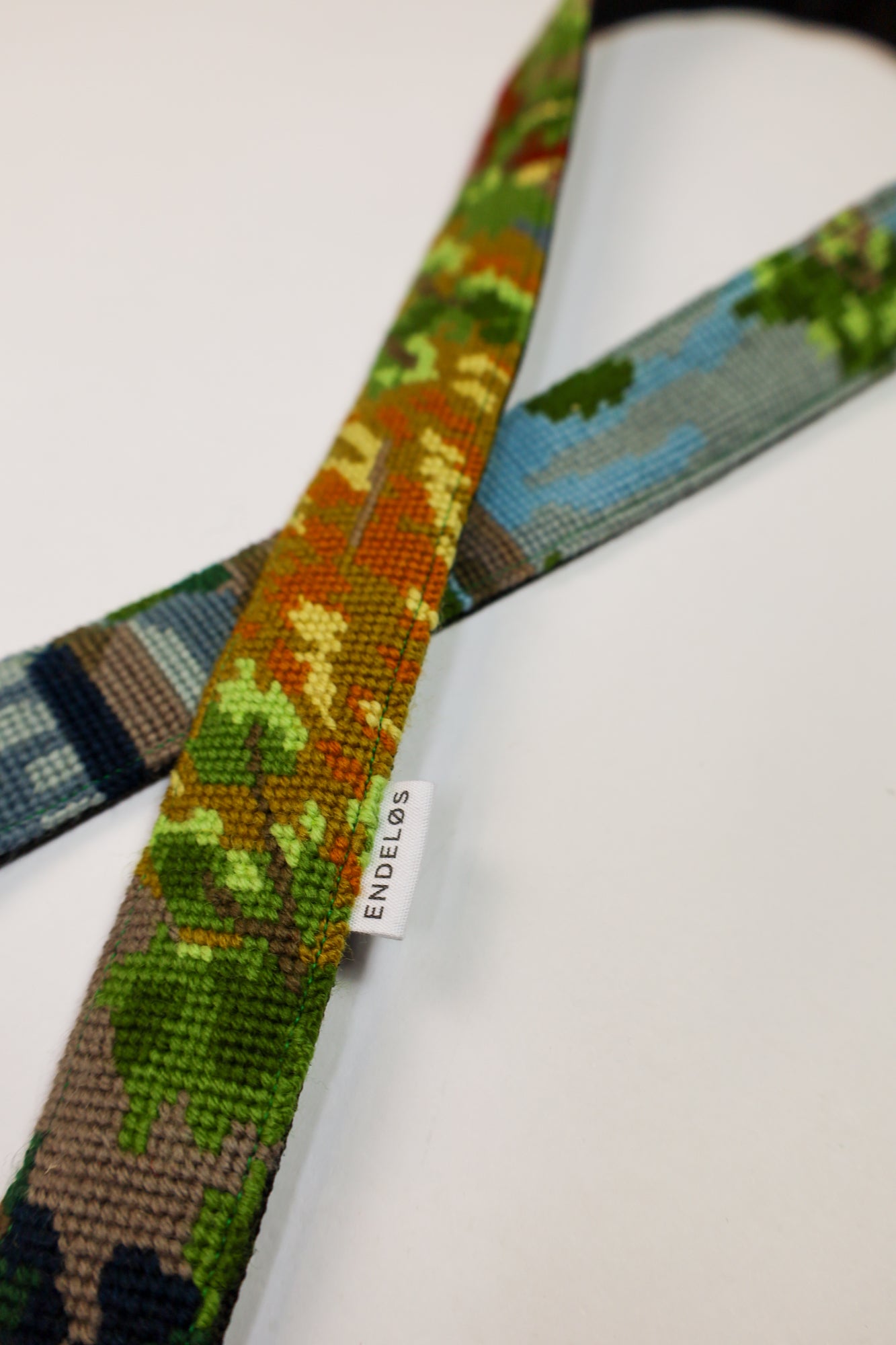 Sustainable strap with an artistic landscape, crafted from upcycled materials.