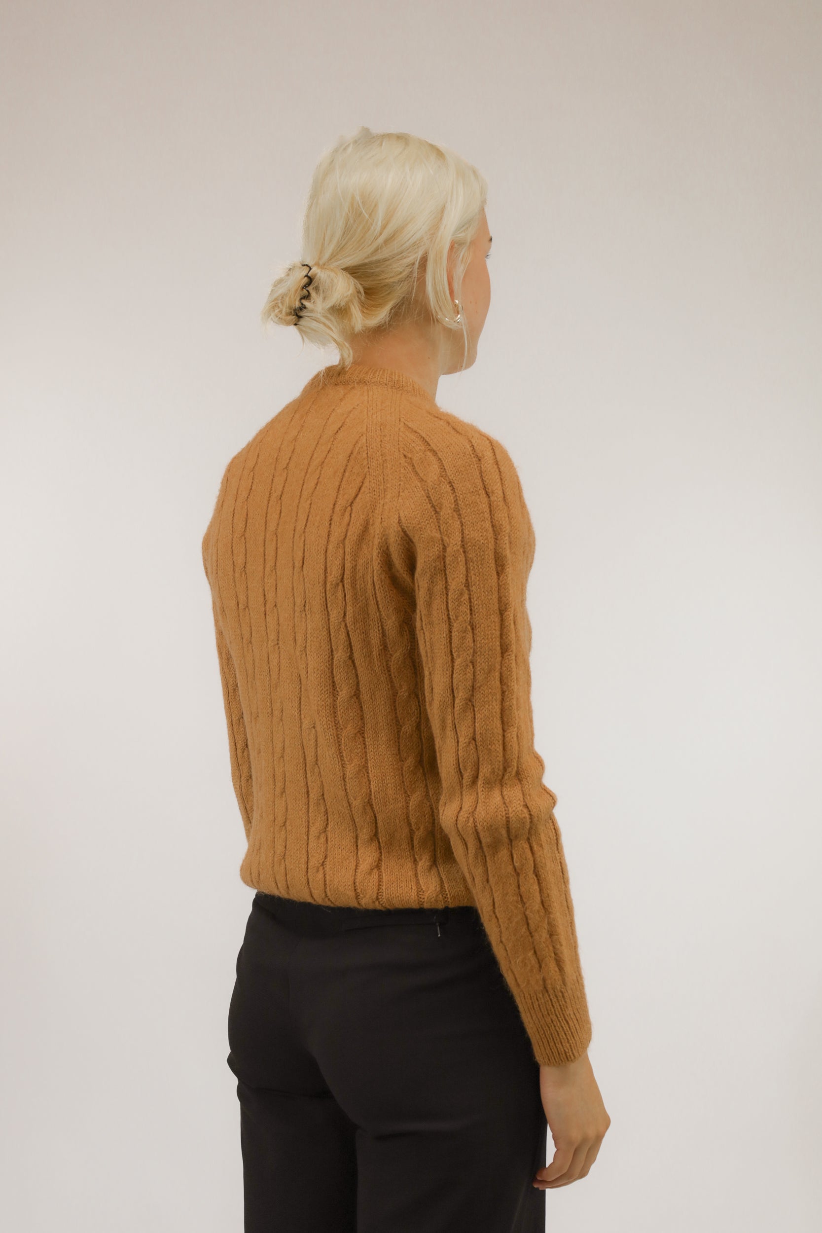 Achteraanzicht van model met cognacbruine trui van wolmix met raglanmouwen