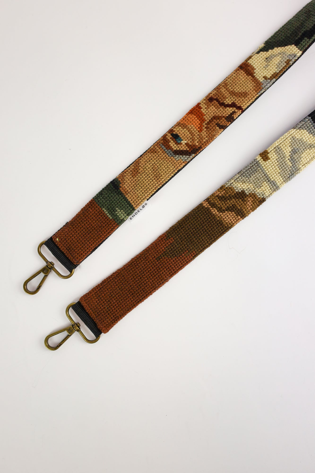 Unique strap featuring an embroidered painting of a drinking man, in deep shades of green, black, and brown, perfect for a stylish touch.