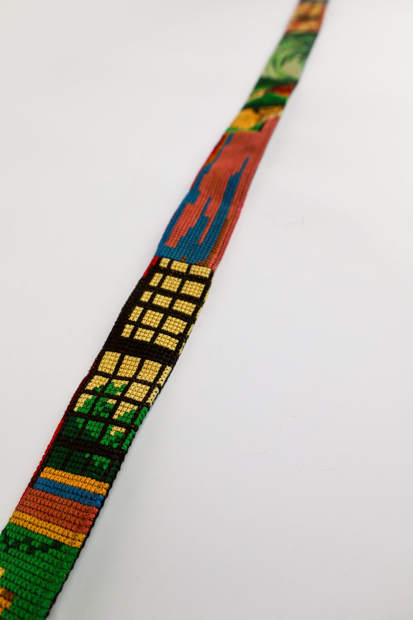 Unique strap crafted from a beautiful embroidered painting, designed to elevate your accessories with a personal, artistic flair and environmentally conscious materials.