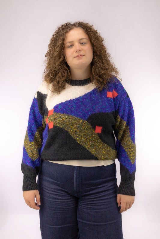 Vintage zwarte knit trui met kleurrijke ingeweven print – vooraanzicht