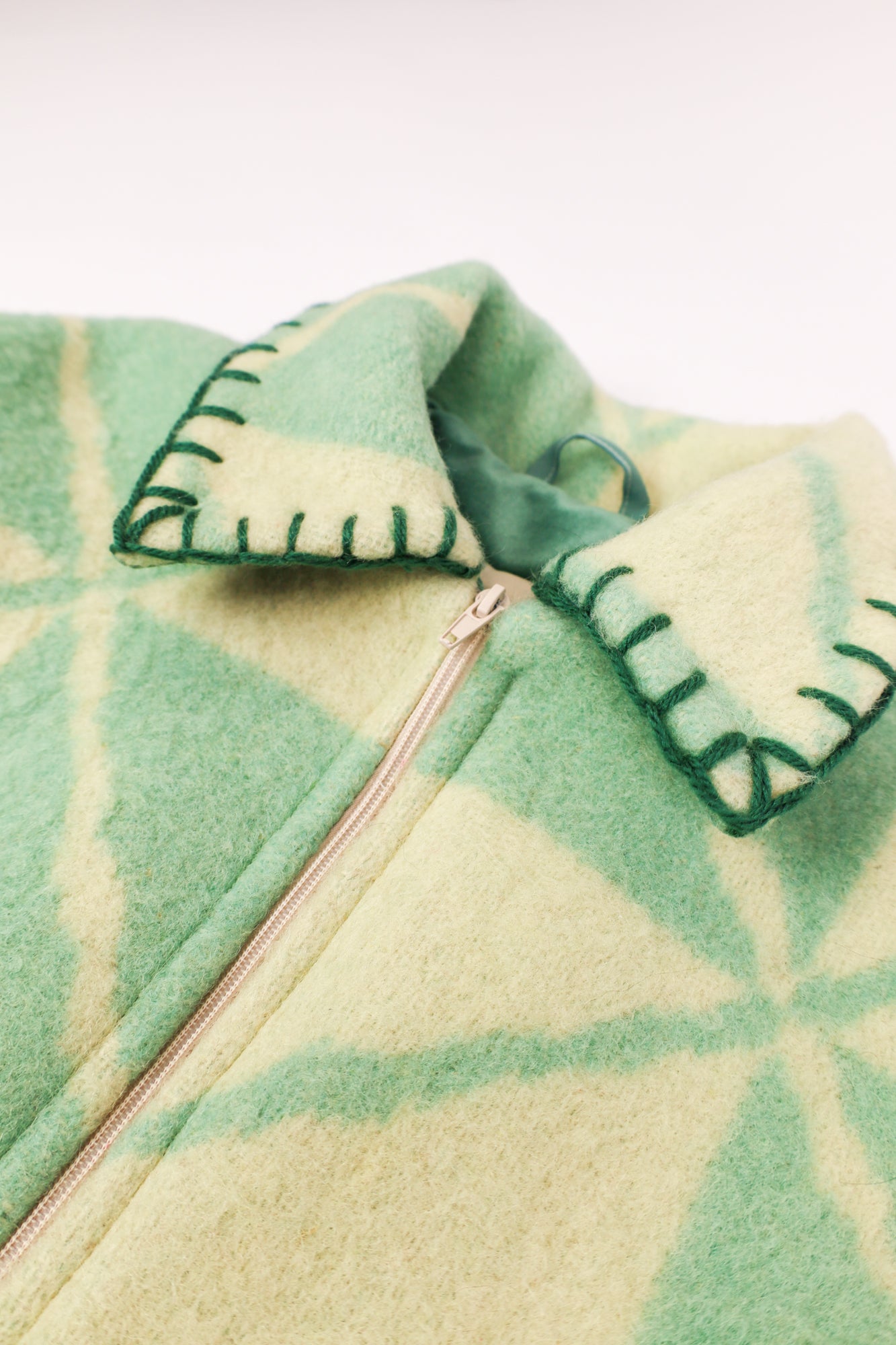 Close-up of the green stitching along the seams, adding a subtle yet cohesive finish.