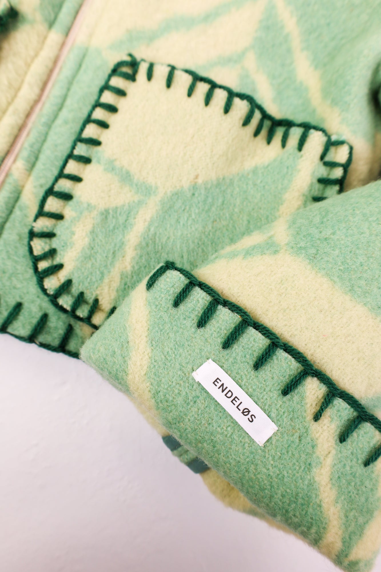 Close-up of the green stitching along the seams, adding a subtle yet cohesive finish.