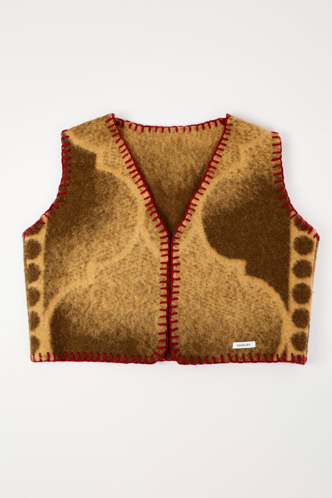 Front view of the handmade oversized vest featuring a vintage wool blanket and deep red stitching.