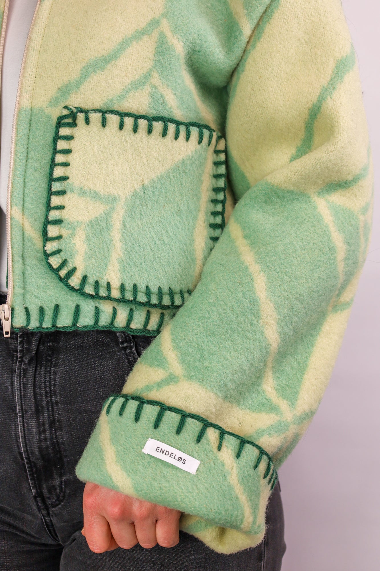 Close-up of the green stitching along the seams, adding a subtle yet cohesive finish.