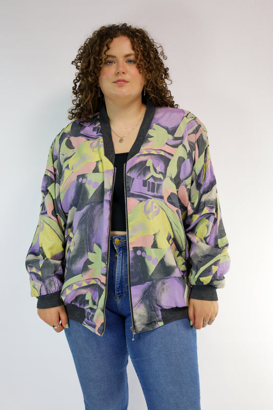 Voorkant van vintage bomberjack met pastel grafische print en ritssluiting